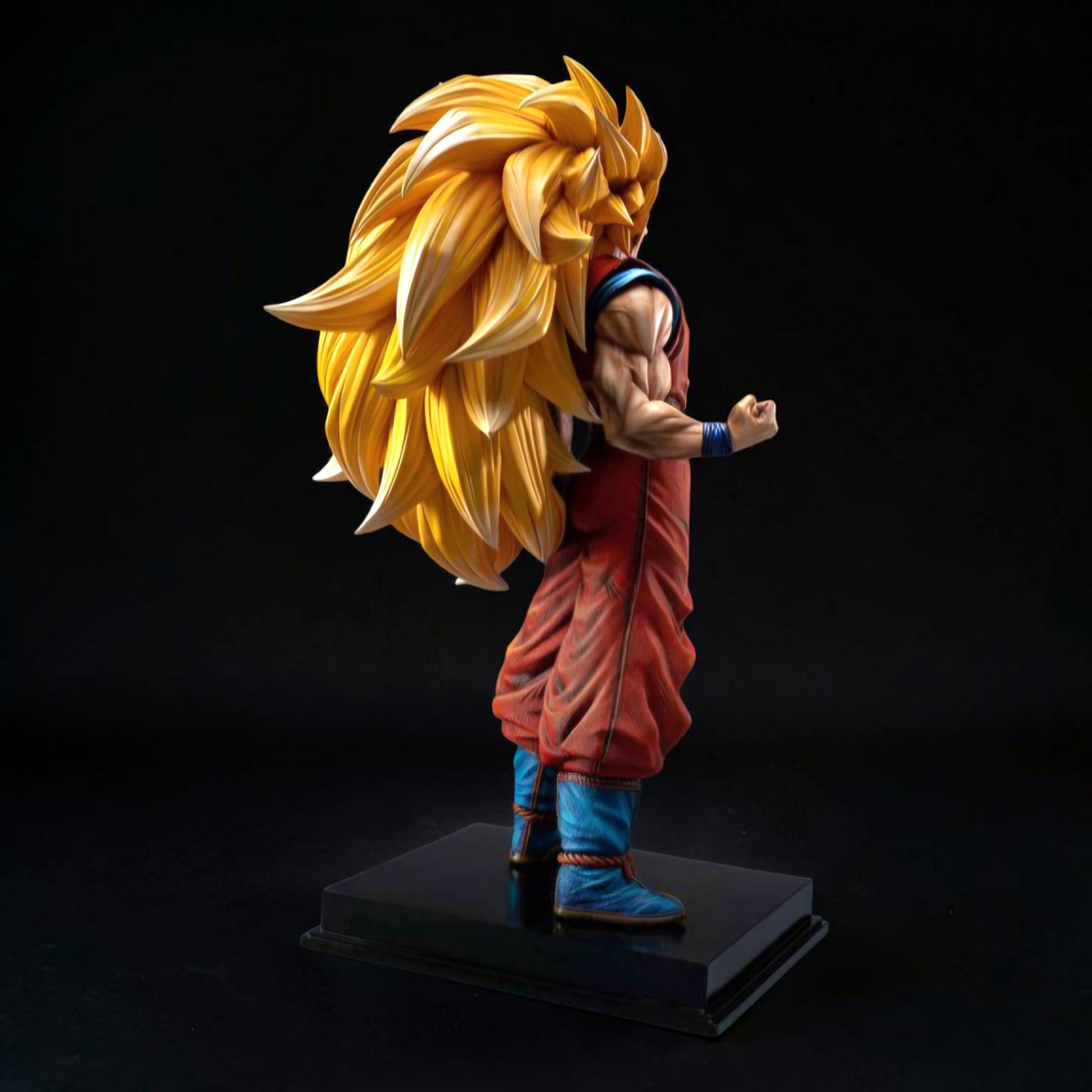 Super Saiyan Goku figure on a black stand against a dark background
